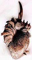 Front view of bronze rooster okimono showing head, body, detailed feathers