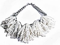 Full view of the heavy vintage pearl necklace showing the clustered pearl sections and silver-tone chain.