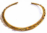 Brutalist solid brass choker necklace angled showing textured surface and shape