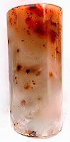 Solid jade vintage vase with creamy white to reddish-brown hues, cylindrical shape.