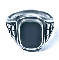 Front view of vintage sterling silver ring with rectangular black onyx stone setting, showing detailed silver work on sides.