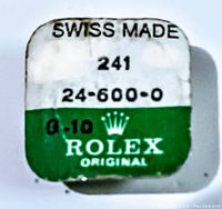 Front of sealed watch part packaging showing Rolex branding, model and serial numbers, marked Swiss Made, with green and white color scheme.