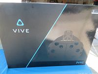 Closed box of HTC VIVE headset with logo and product outline on the front.