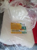Photo of sealed bag containing the 10-pound white wax chunks intended for candle making, with label visible showing product information.