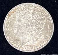 Front view of 1898 Morgan Silver Dollar showing Liberty profile and date