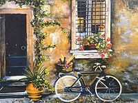 Close-up of canvas print showing bicycle with picnic basket and flowers on a textured wall next to a door and window with shutters.