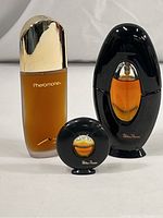 Photo of all three perfume bottles together, front view showing labels and bottle shapes.