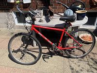 Side profile of the red BRC mountain bike showing full frame and tires.