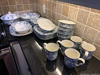 Overall view of dishes arranged on countertop showing variety and condition