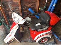 Left side view of red and white scooter showing overall body and wheel configuration
