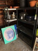 Two black plastic shelving units with multiple items on shelves, shown for size reference only.