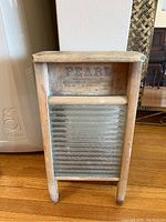 Full view of vintage washboard showing wooden frame and metal scrubbing surface.