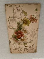 Full view of the antique 1897 calendar showing floral illustration and calendar months.