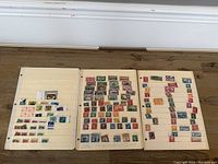 Three album pages laid flat showing a variety of used stamps mounted in rows