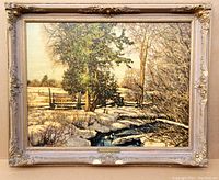 Full view of framed Franz Johnston landscape print showing winter/early spring scene with trees, snow, and stream in decorative carved wooden frame.