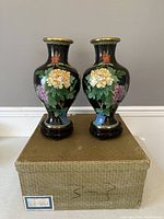 Front view of both vases on original box showing full shape and design.