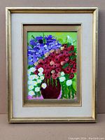 Framed oil painting showing the entire artwork with floral bouquet in a multicolored palette, mainly reds, purples, and whites on a vibrant green background.