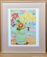Framed watercolour painting of flowers in a striped vase with multicolored background.