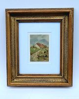 Frontal view of the framed watercolour painting of rural cottage showing full frame and mat board.