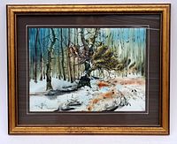 Framed watercolor and ink painting of a tree in a winter landscape, showing the whole artwork and frame, with a brown and white layered mat and gold-tone wooden frame.