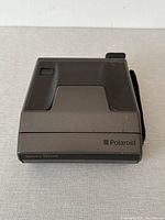 Front top view of vintage Polaroid Spectra System camera showing front panel and branding.