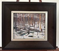 Overall view of framed lithograph showing dark wood frame with silver liner and winter forest scene