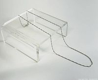 Full view of the 17-inch delicate 10K white gold twisted rope chain necklace displayed on a clear stand