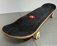 Side angle showing the full length of the skateboard with visible Airwalk logo and grip tape condition