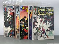 Front view of 7 comic books showing titles Spider-Man, Go (No 1), Green Lantern (No 27), Marvel Team-Up Spider-Man and Kitty Pryde