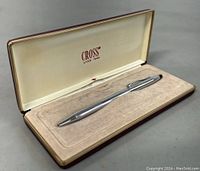Silver-colored Cross pen in original cream velvet-lined box, showing pen clearly in case