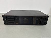 Full front view of Nakamichi BX-125 cassette deck showing cassette compartment, button controls, and tape transport area.