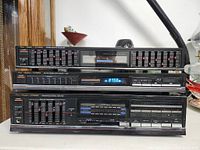 Front view of the three stacked Fisher stereo units: equalizer on top, tuner in the middle, and amplifier with cassette decks on the bottom.