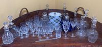 Full view of the barware collection including decanters and assorted glasses arranged on wooden tray