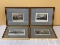 Four framed Canadian prints arranged in two rows of two, showing their fronts with blue and white matting and gold frames on a white surface.