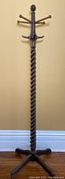 Full front view of entire coat tree showing hooks, arms, finial and base