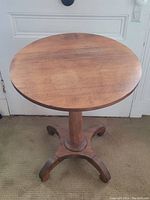 Top view showing round wooden tabletop with natural wear marks.