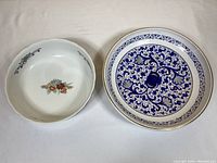 Top-down view showing floral interior of Arita ware bowl and intricate blue pattern of CACF Faenza bowl.