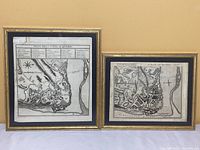 Both framed vintage maps of Quebec City side by side against a yellow wall.