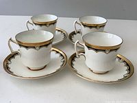 Four matching Royal Chelsea cups and saucers arranged showing the pattern and condition.