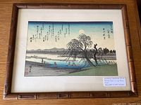 Framed Japanese woodblock print showing overall artwork and frame.