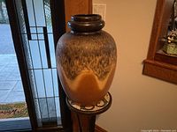 Full front view of large vintage Scheurich fat lava floor vase showing overall shape, glaze color transitions from brown mottled top to lighter wave bottom, and thick circular neck.