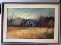 Full view of framed original oil painting depicting old barn in rural landscape with golden grass and autumn trees.