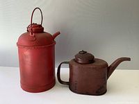 Front and side overview of the two CNR oil cans showing size difference and condition.