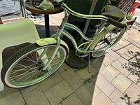 Full side view of vintage Huffy cruiser bike highlighting large cream-colored fenders and white wall tires.