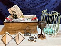 Complete lot showing wooden planter box with bulbs, metal and glass goblet, metal lantern, and two metal and ceramic wall planters.