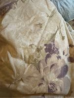 Close-up of cream colored duvet cover with plum floral pattern