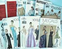 View of 10 various ladies sewing pattern envelopes including McCall's, Vogue, Butterick, and Simplicity showing elegant evening and casual wear.