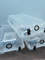 Three clear plastic shoe storage bins stacked, showing finger holes with black ring and black clip locks on sides