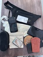 Overview of travel bags and wallets laid out on table showing variety of styles and compartments