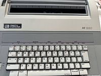 Front view showing keyboard layout with Smith Corona branding and XE 1980 model designation.